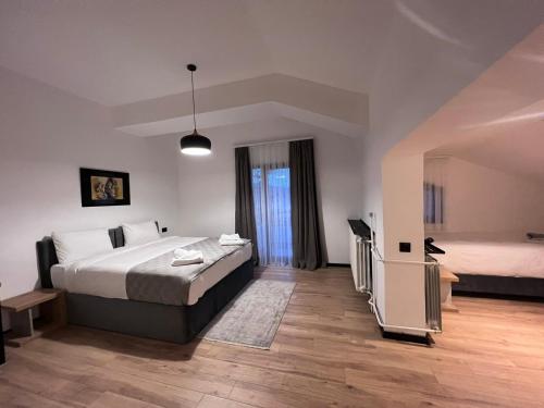 a bedroom with two beds and a window at LAKEVIEW Hotel & Apartments in Mavrovo