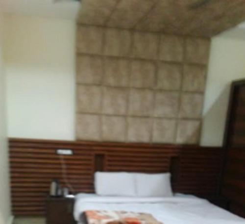 Ένα ή περισσότερα κρεβάτια σε δωμάτιο στο Tapovan Residency By WB Inn