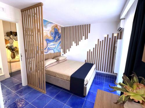 a small bedroom with a bed in a room at Residenza AquaLaguna in Tropea