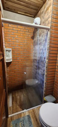 a bathroom with a shower with a toilet at Pousada Bella Rosa - Capão da Canoa in Capão da Canoa