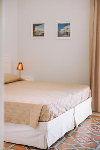 a bedroom with two beds in a room at Lamare cucina e dimore in Polignano a Mare