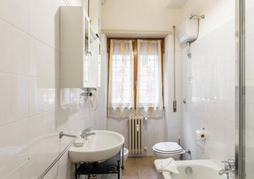 a white bathroom with a sink and a toilet at Navona Home in Rome