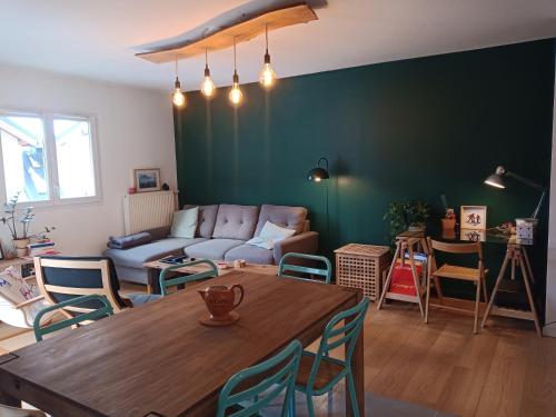 a living room with a table and a couch at Apartment In Allemont in Allemont