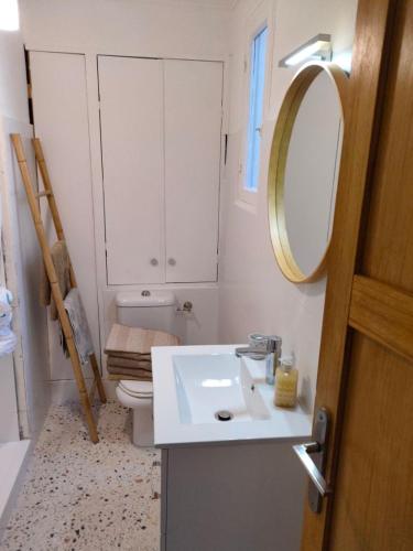 a bathroom with a sink and a toilet and a mirror at Beau 3 pieces proche centre in Menton