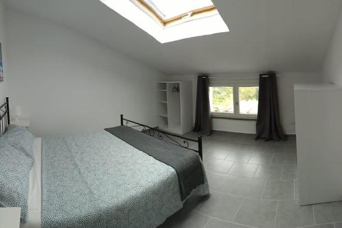 a bedroom with a bed and a window at La casa accanto in Rio nellʼElba