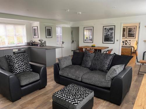 a living room with a couch and a table at Booking Urban at Stisted in Braintree