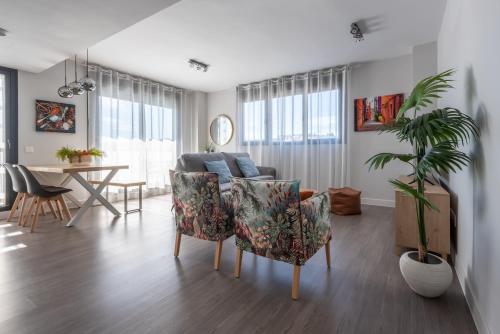 a living room with a couch and chairs and a table at Apartamento Estepona I in Estepona