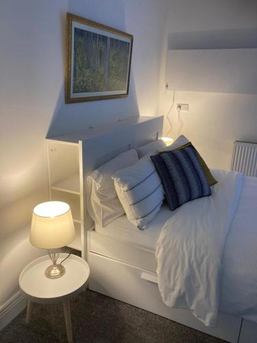 a bedroom with a bed with blue and white pillows at Kilpatrick Glebe in Crossabeg