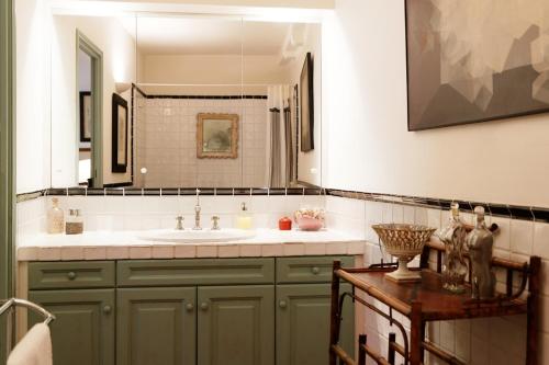 een badkamer met een wastafel en een spiegel bij La Maison du Prince in Grimaud