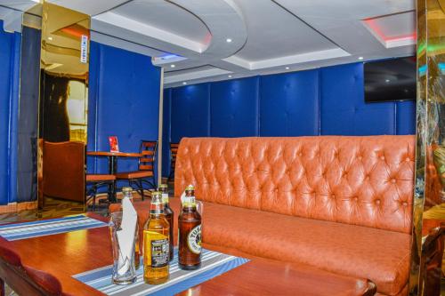 a bar with two bottles of beer on a table at Breeze Hotel Nyahururu in Nyahururu