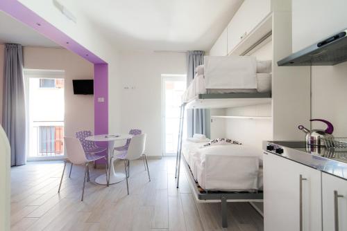 a room with a bed and a table with chairs at La casa dei tre pesci - Appartamento Lavarello in Torno