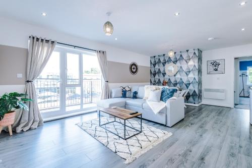 a living room with a couch and a table at Formby Village Apartments By Greenstay Serviced Accommodation - Perfect For SHORT & LONG STAYS - Couples, Friends, Families & Business Travellers All Welcome - Dog Friendly - 7 in Formby