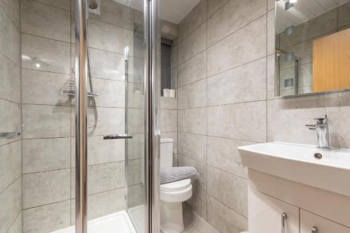 a bathroom with a shower and a toilet and a sink at Bedford Road in Reading