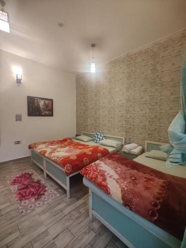 a room with two beds in a room at The Bunker House in Chopta