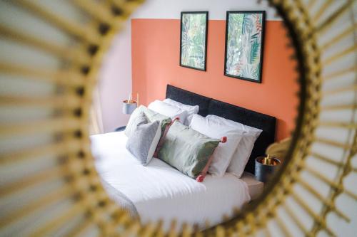 a mirror reflecting a bed with pillows on it at Formby Village Apartments By Greenstay Serviced Accommodation - A Luxury 2 Bed Apt - Perfect for Couples, Friends, Families & Business Travellers - FREE Parking - Dog Friendly - Fast Wi-Fi - 6 in Formby