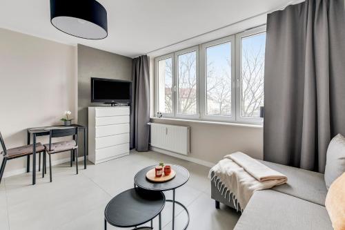 a living room with a couch and a table at Comfort Apartments Morska in Gdynia