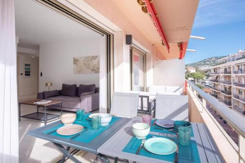 d'une table sur un balcon avec vue sur le salon. dans l'établissement Amazing Apartment With Private Terrace & Full Air Conditioning - Walk To The Beach, La Croisette! - Latour Maubourg 18 by Halldis, à Cannes
