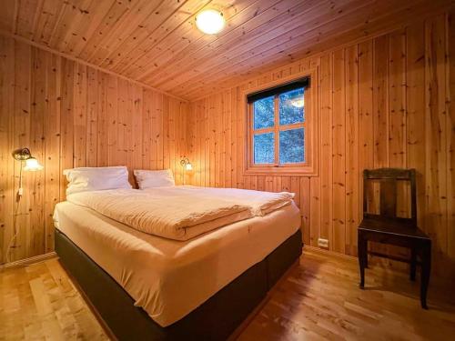 a bedroom with a large bed in a wooden room at Fairytale STAYcation 