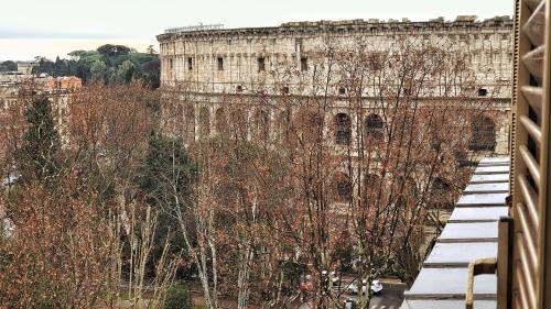 a view of the coliseum from the balcony of a building at DrsRome - Roman's Ruins Colosseum in Rome