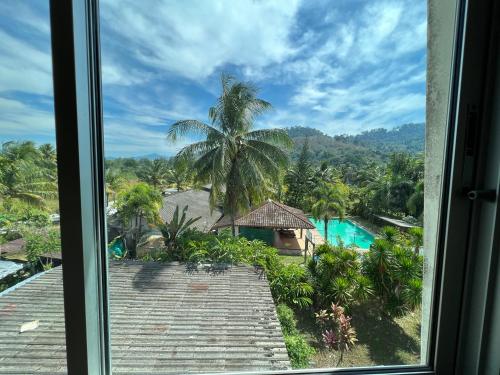 a view from a window of a resort with a pool at RT KhaoLak Hotel in Khao Lak