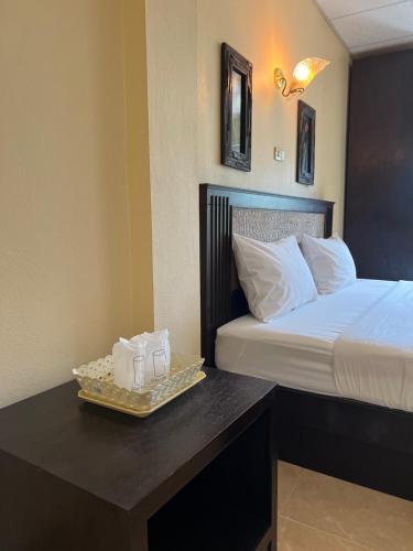 a hotel room with a bed and a tray with towels at RT KhaoLak Hotel in Khao Lak