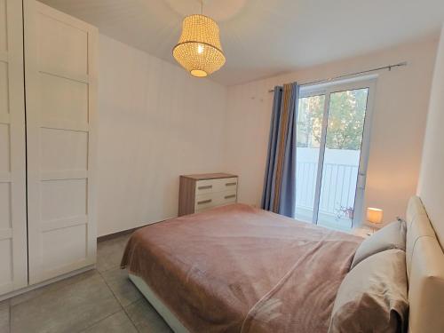 a bedroom with a bed and a large window at Large Central Apartment Near Valletta & Seafront in Pieta