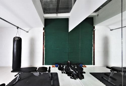 - une salle de sport avec des chaises noires et un mur vert dans l'établissement Grand House of Character Valletta, à Il-Furjana