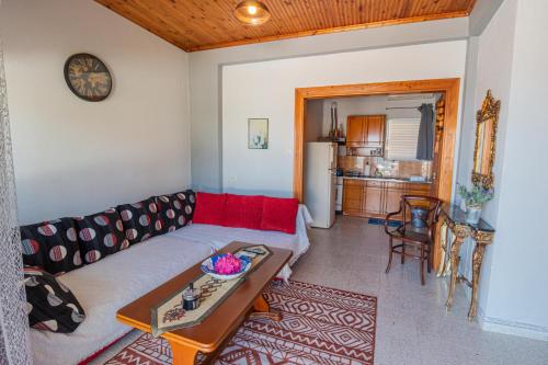 a living room with a couch and a table at Fantasea Apartments in Stómion