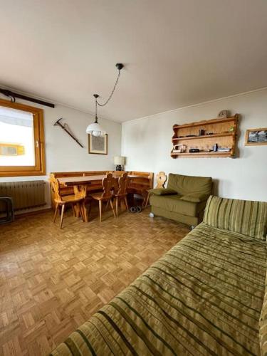 a living room with a couch and a dining room at Appartamento Rin, Livigno in Livigno