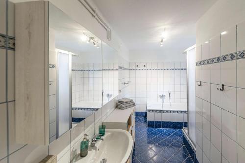 a white bathroom with a tub and a sink at Das Haus in Altaussee - Your Austrian Home in Altaussee