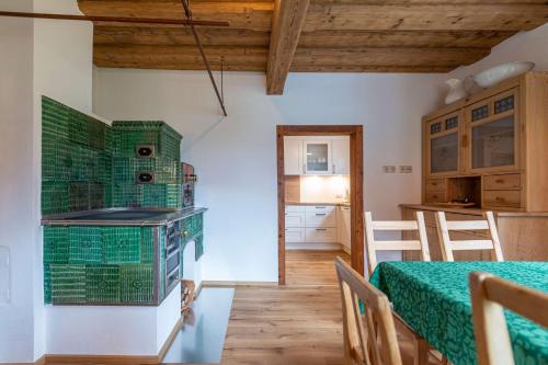a kitchen and dining room with a table and a stove at Das Haus in Altaussee in Altaussee