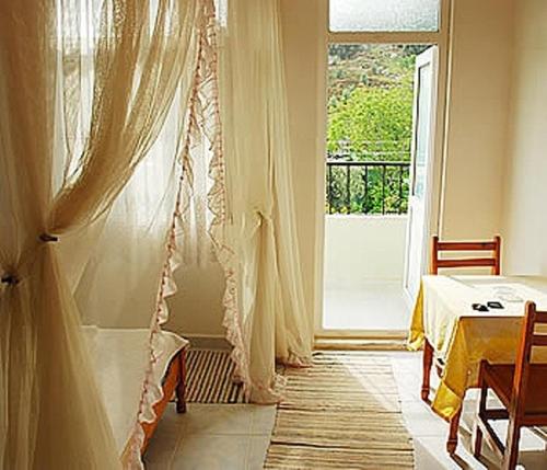 a room with a bed and a window and a table at Akay Hotel in Patara