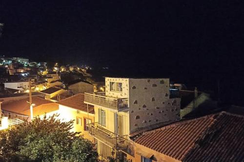 a view of a city at night with buildings at Io the cosy home Plomari in Plomari