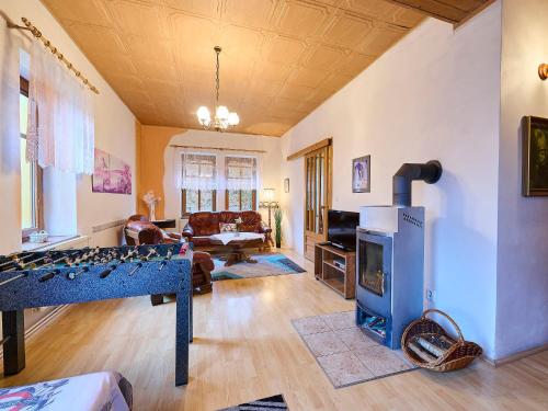 a living room with a foosball table in front of a fireplace at Holiday Home Zlata Olesnice by Interhome in Zlatá Olešnice