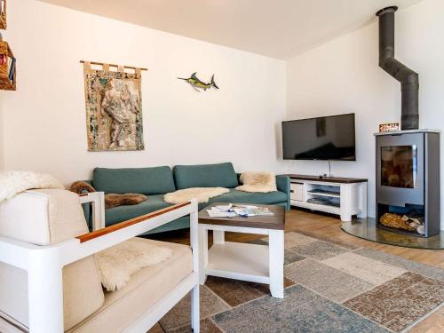 a living room with a couch and a tv at Holiday Home Lakeside Village 11 by Interhome in Frymburk