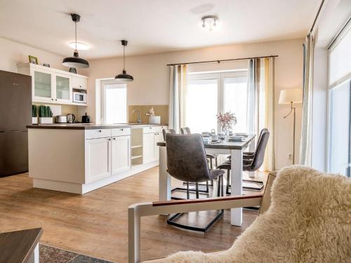 a kitchen and dining room with a table and chairs at Holiday Home Lakeside Village 11 by Interhome in Frymburk