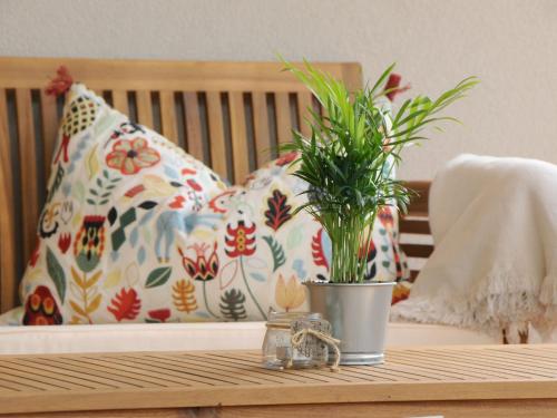 a potted plant on a table with a pillow at Apartment Wanglblick by Interhome in Tux