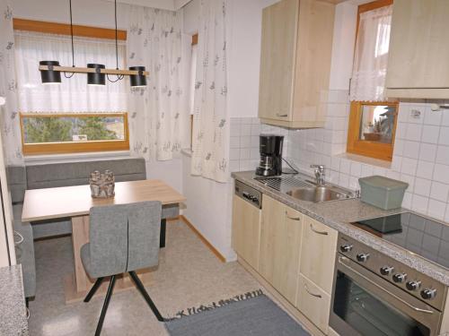 a small kitchen with a table and a sink at Apartment Schlatter by Interhome in Fliess