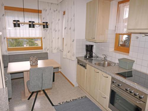 a small kitchen with a table and a sink at Apartment Schlatter by Interhome in Alterzoll