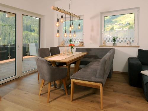 a dining room with a table and chairs at Apartment Haus Stock by Interhome in Tux