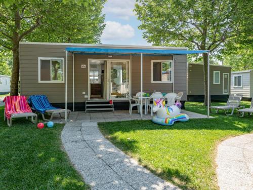 a tiny house with a porch and a patio at Holiday Home Garda Family Plus by Interhome in Rivoltella