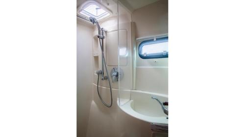 a bathroom with a shower and a sink at Sabba Whitesand Catamaran in Fodhdhoo