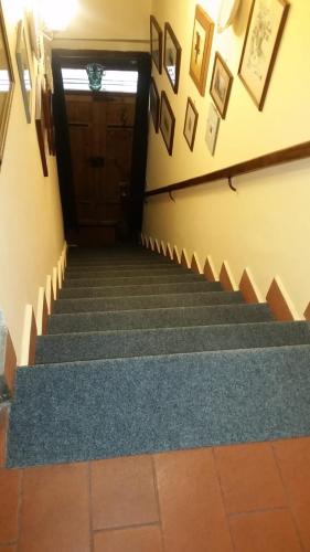 a set of stairs in a building with a door at Alloggio Turistico Centro Storico Malatesta in Montefiascone