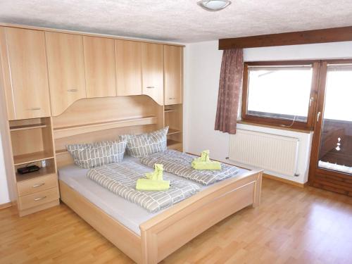 a bedroom with a bed with two rubber ducks on it at Holiday Home Plattner-2 by Interhome in Oetz