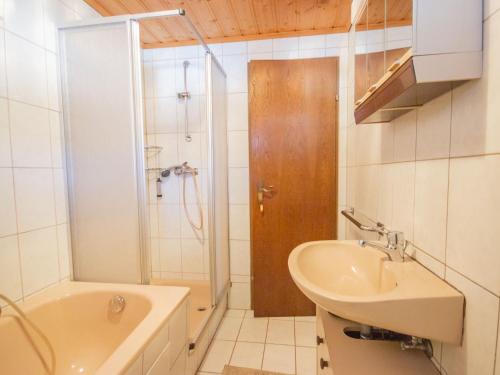 a bathroom with a shower and a sink and a tub at Holiday Home Plattner-2 by Interhome in Oetz