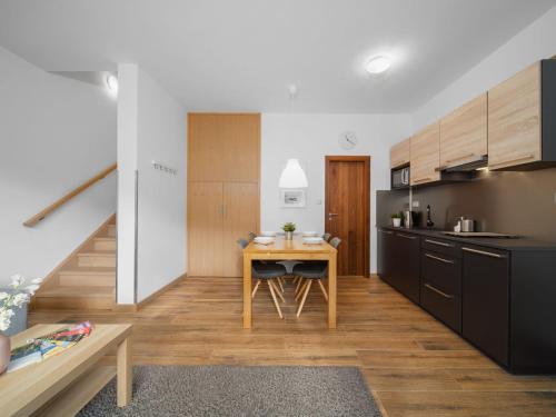 a kitchen with a wooden table in a room at Apartment Ski-In Ski-Out Mountain Duplex Portášky3 by Interhome in Pec pod Sněžkou