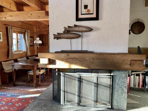 a wooden table in a room with a dining room at Chalet Chalet Rodas 9 by Interhome in Malmigiuer
