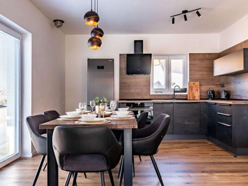 a dining room with a table and chairs in a kitchen at Holiday Home Lakeside Village 40 by Interhome in Frymburk