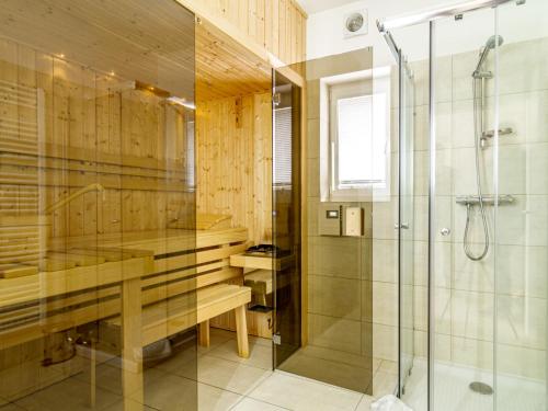 a bathroom with a shower and a glass shower stall at Holiday Home Lakeside Village 18 - - sauna by Interhome in Frymburk