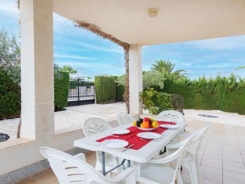 a white table and chairs on a patio at Villa Villa Tello by Interhome in L'Ametlla de Mar